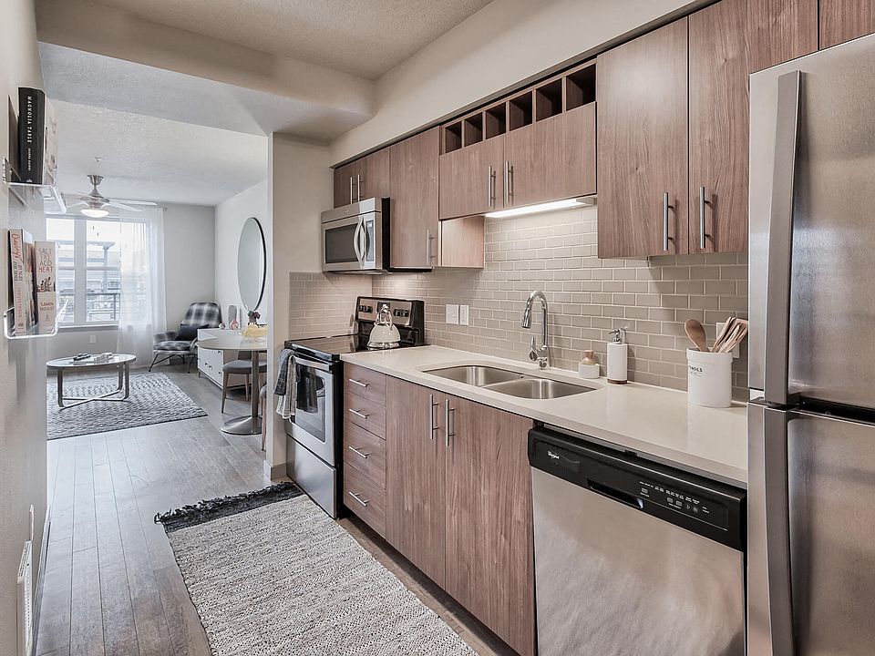 Kitchens feature built-in microwaves and stainless steel appliances