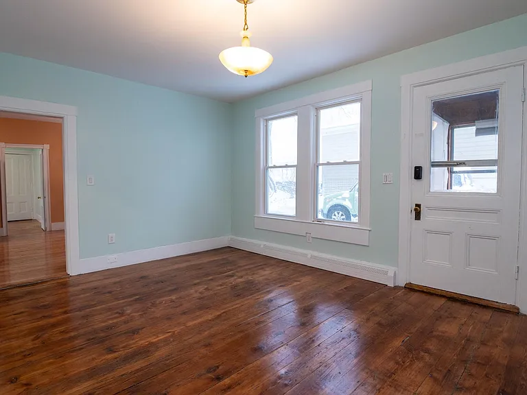 view 2 of living room showing entry door to front porch