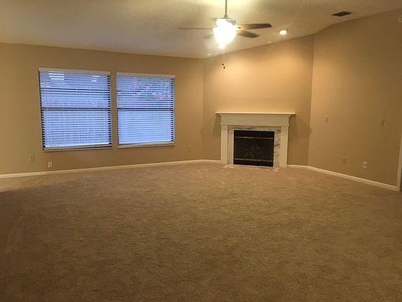 Great room with vaulted ceiling and fire place
