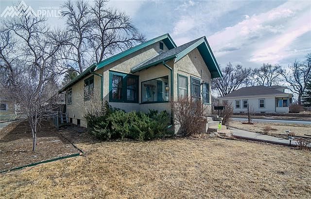 Stucco bungalow with enclosed porch