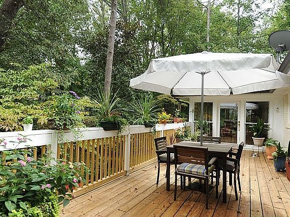 Large back deck with stairs leading the the large, private fenced in backyard!