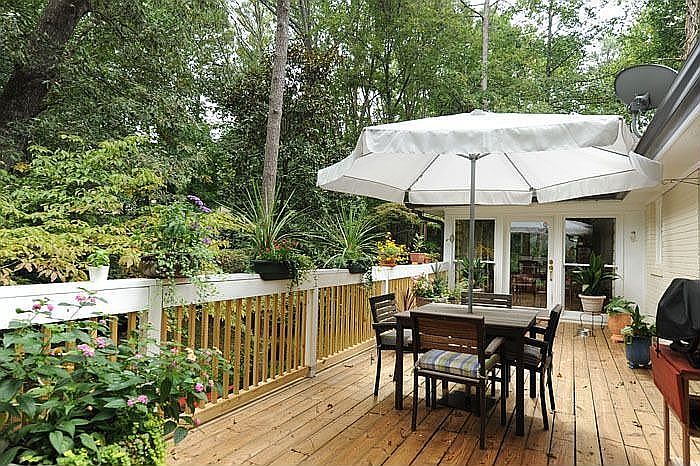 Large back deck with stairs leading the the large, private fenced in backyard!