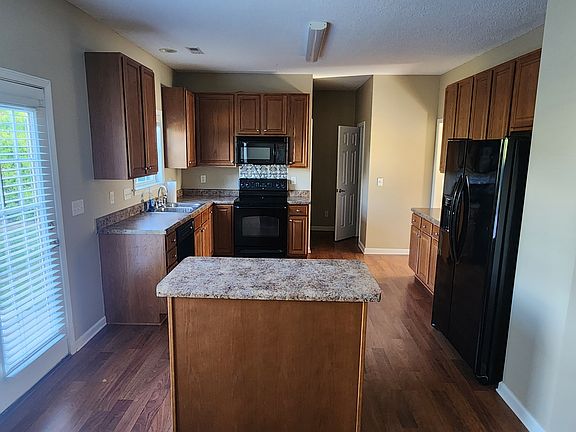 Range/microwave, dishwasher and refrigerator. Large pantry and separate laundry room off kitchen.