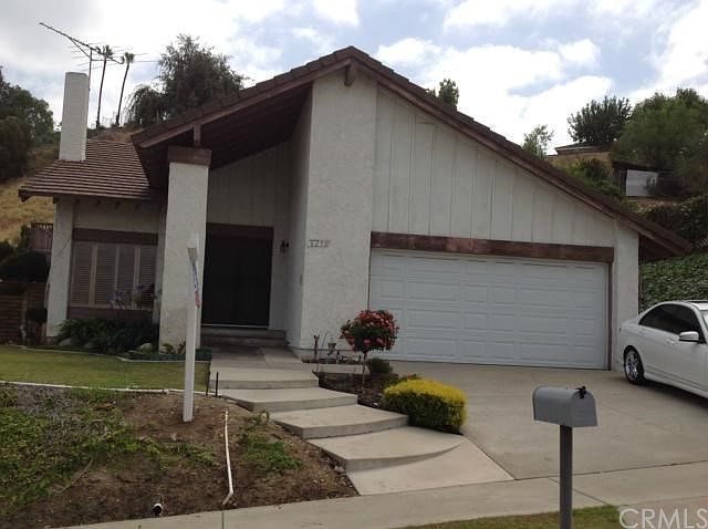 Front View of House & Well Manicured Landscape.