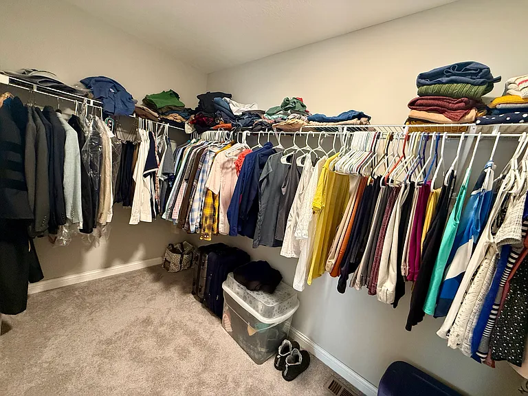 Primary bedroom walk-in closet