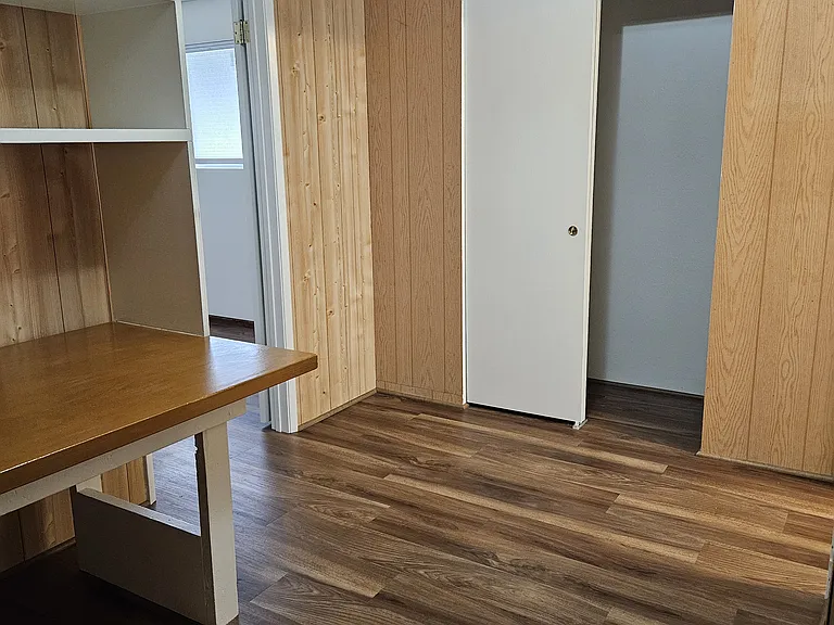 View of room with desk, showing closet on S side of room