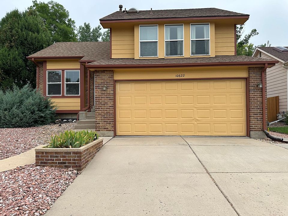 Front of house with zero scape and double car garage