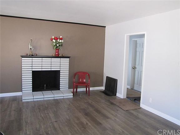 living room with cozy fireplace and laminate floors