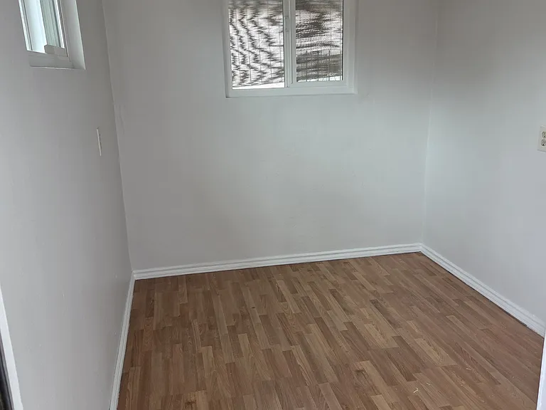Bonus room that can be used as an office space or for storage. View from backdoor of home that leads to private patio.