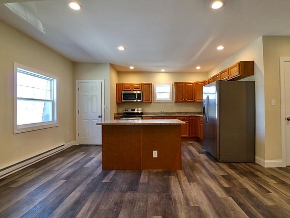 Kitchen w/stainless steel appliances, and granite counter-tops.