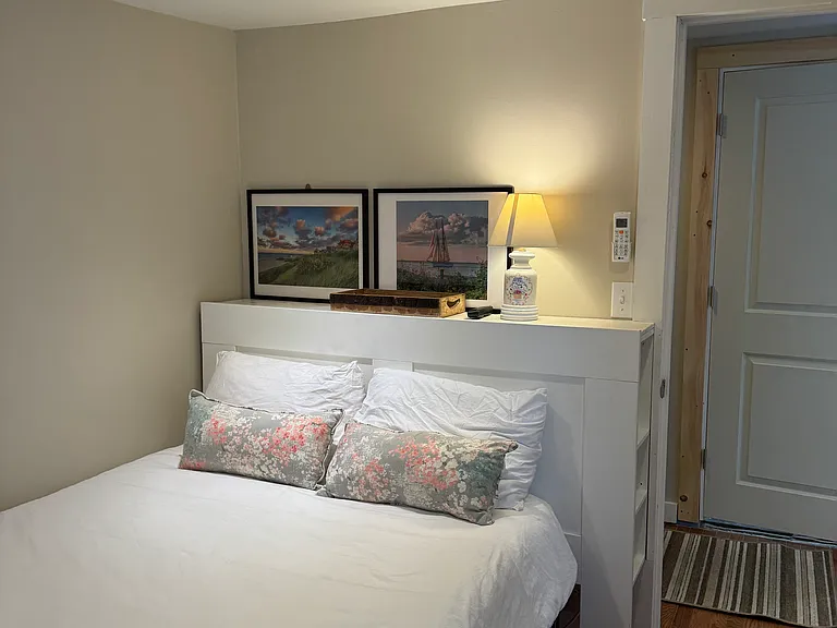 Second bedroom with full size bed, two windows, zoned AC/heat and a small closet.