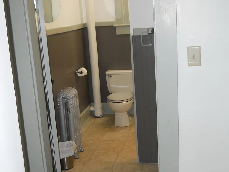 Bathroom is totally functional within moderate space. Full sized tiled shower, commode, large shelving area and vanity will definelty suffice for all needs. New water tight flooring will make clean-up easy.