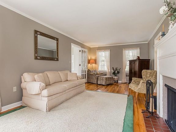 Living Room with Fireplace, hardwood floors and french doors that lead into office/den