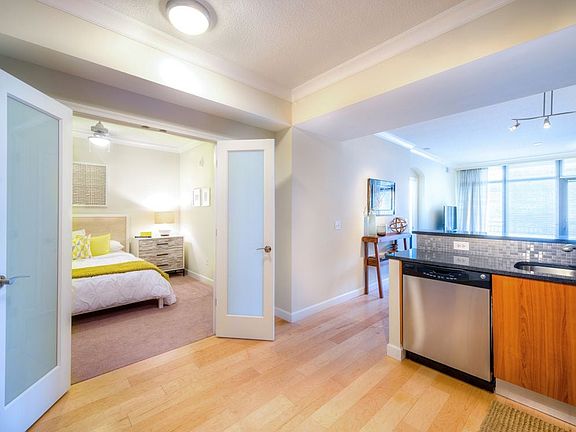 Open concept kitchen and carpeted bedroom