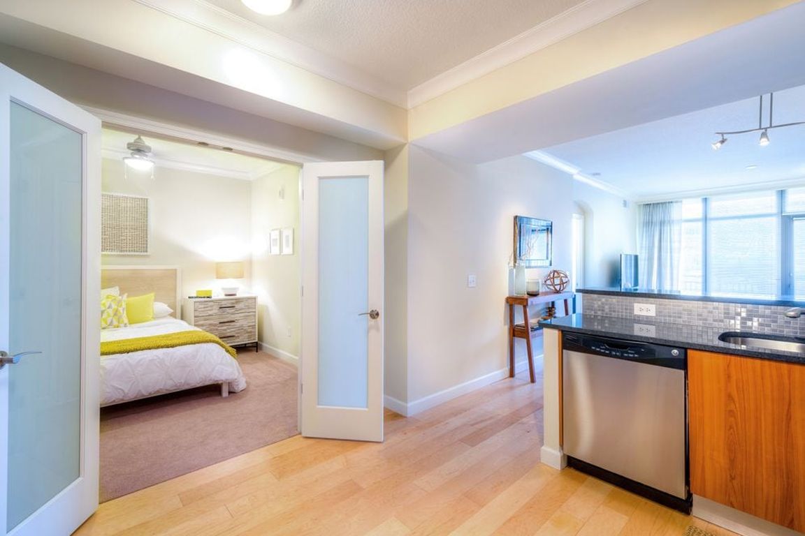 Open concept kitchen and carpeted bedroom