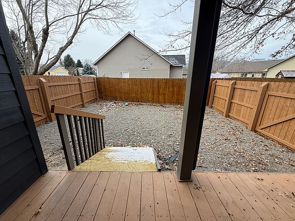Dog yard has gates to front yard, back yard, and deck.
