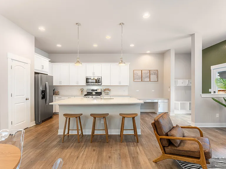 Bright modern home with cozy living room, open kitchen with island and stainless steel appliances, and spacious dining area. Perfect spaces for long stays with family or friends. Your home away from home!