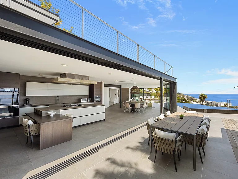 The open layout seamlessly integrates the kitchen, dining, and living spaces for a cohesive feel.