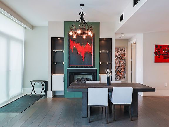 Display shelving along the fireplace with included artwork to enjoy.