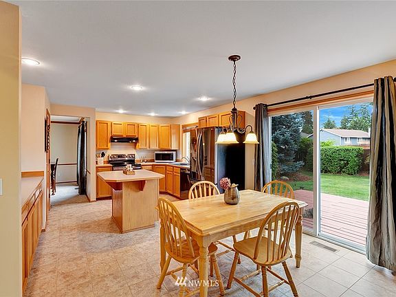 The kitchen eating area has a sliding door to the huge deck and beautifully landscaped yard.