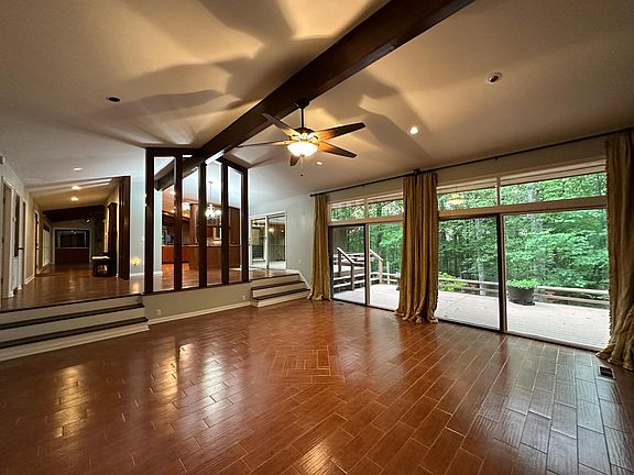 Living Room with window wall and view of back yard and deck.