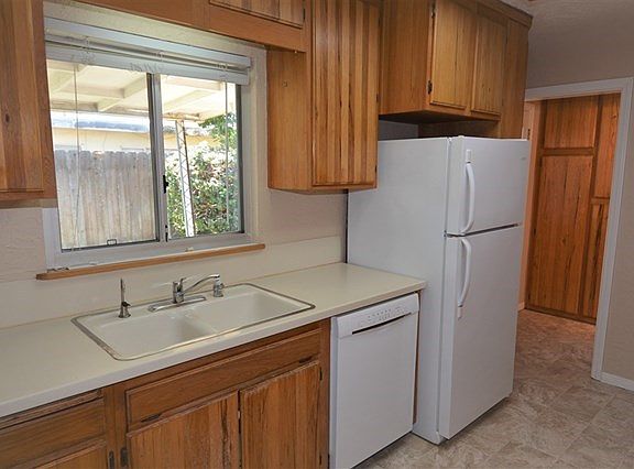 Updated Corian Counter tops and back splashes make food preparation and clean up a breeze. Past the refrigerator... a Mud Room r