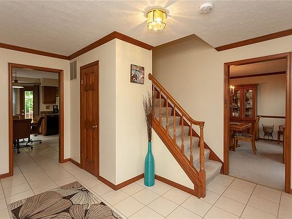 The foyer offers ceramic tile flooring and a spacious coat closet. Just to the right is a formal dining room.