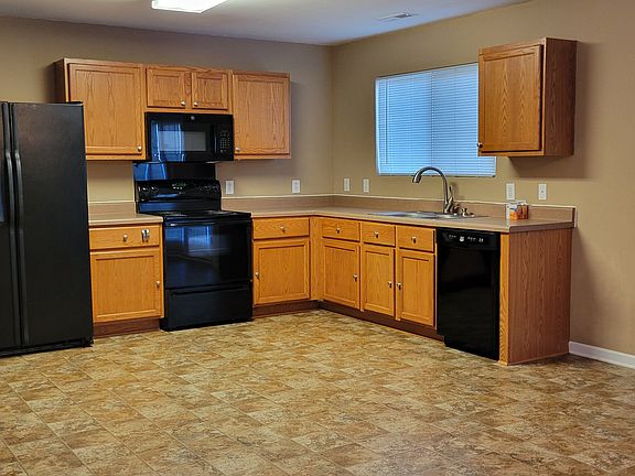 Kitchen with fridge, microwave, stove, garbage disposal, and dishwasher.