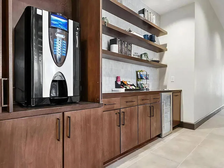 Self-Serve Coffee Machine and Snack Area in Clubhouse Hallway