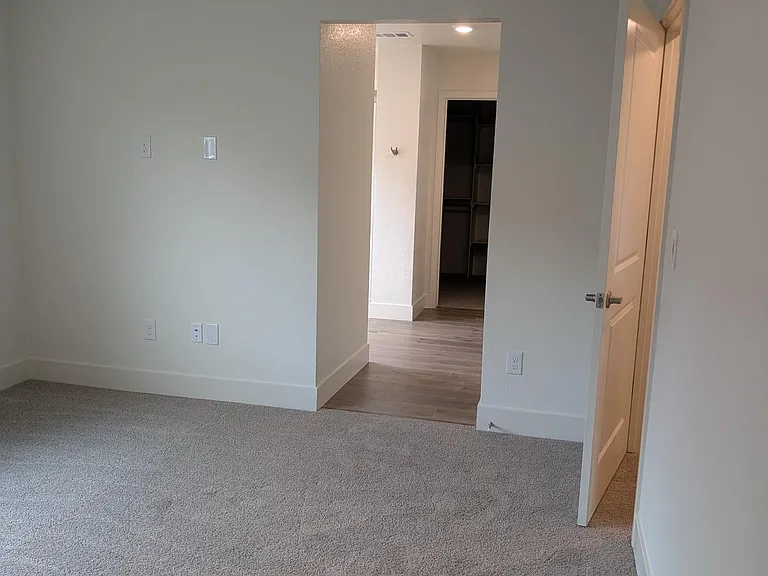 Master bedroom looking into its bathroom and large walk-in closet