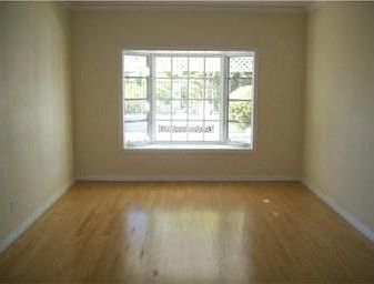 Living room with bay window & hardwood floors