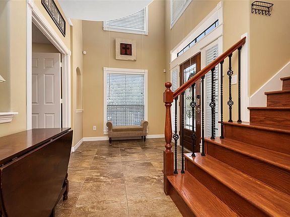 Another view showing the custom railing and woodwork around all those windows, lots of natural light!