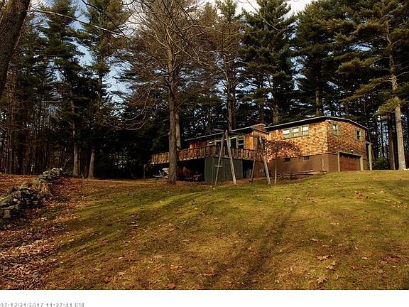 View from the back with yard that extends to the stone wall.
