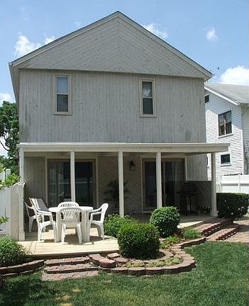 Grill out on your covered back deck surrounded by perennial gardens. 