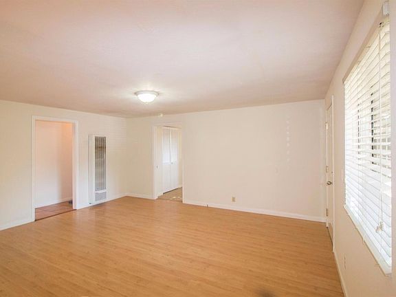 Living room connects to kitchen, third bedroom and hallway