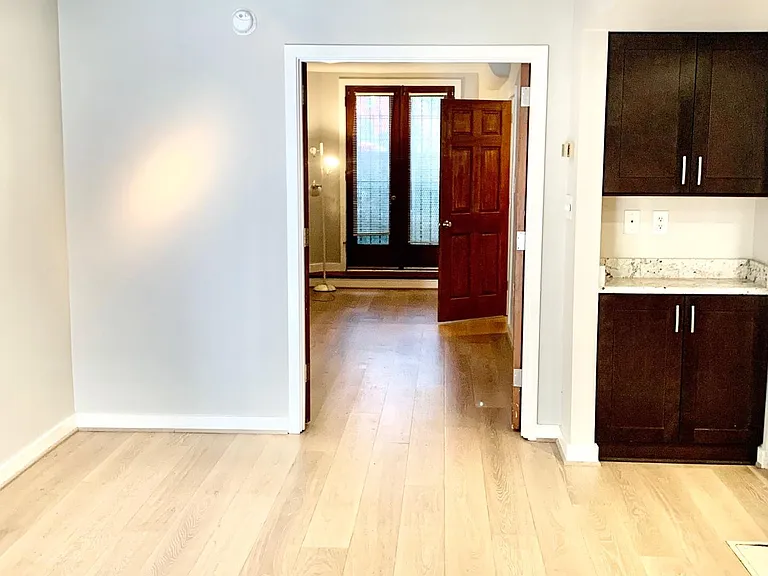 Walking from the dining area into the bedroom