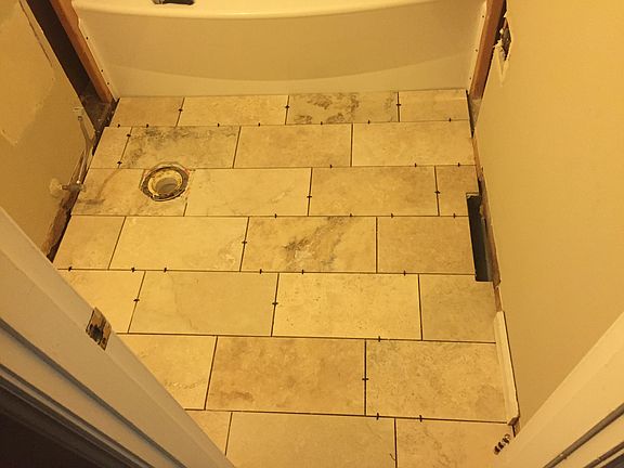 Travertine tile being instal