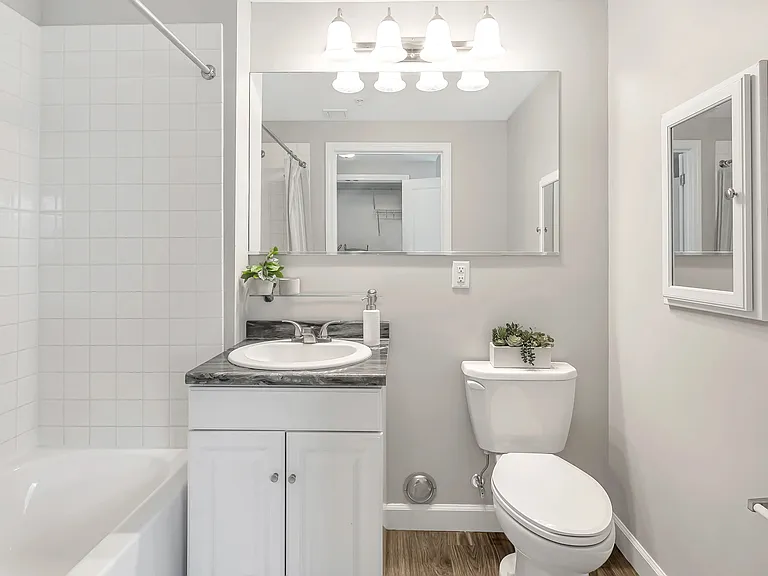No matter what the day has in store, get ready for the day and feel at your best in your own brightly lit bathroom with white tile surround, large mirror, and personal medicine cabinet to store all of your essentials.
