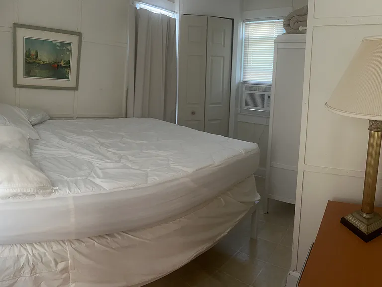 downstairs queen bedroom off kitchen with adjacent half bath.
