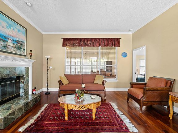 Formal living room and granite double fireplace. Property comes furnished as seen in photos