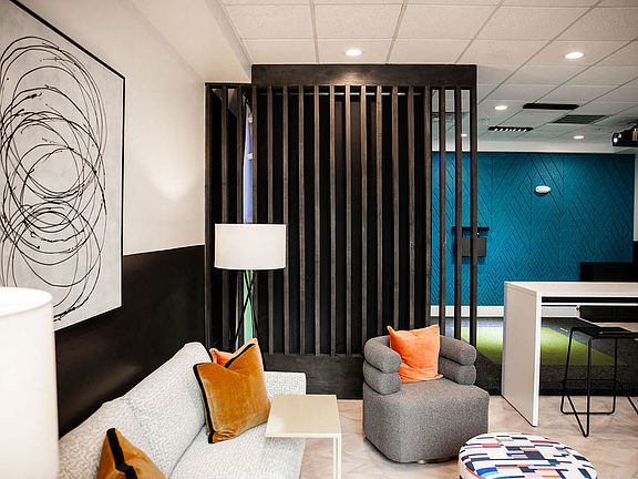 Resident Lounge Featuring Accent Wall, Bar Seating, and Relaxed Social Space