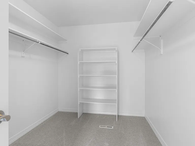 The oversized walk-in closet includes built-in organization and abundant storage space.