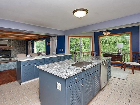 This space would make a perfect breakfast nook and offers two sliding doors to the rear deck as well as a huge center island gre