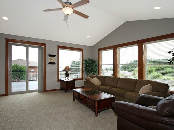 Large open living room with over sized windows to take full advantage of the sound and mtn view including a view of Mount Baker on clear days. Vaulted ceiling and quality wood wrapped windows. Sliding glass door leads tp composite view deck.