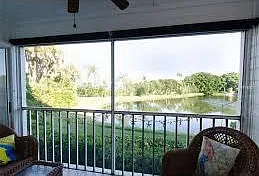 Enter the screened in porch from the living room and the master bedroom for this water and sunset view.
