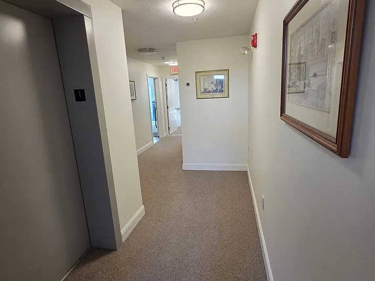 View from elevator to unit door. About 15-20 feet.