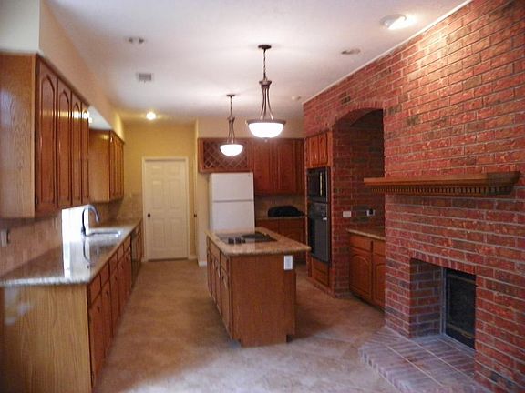 Large kitchen with island cooktop.