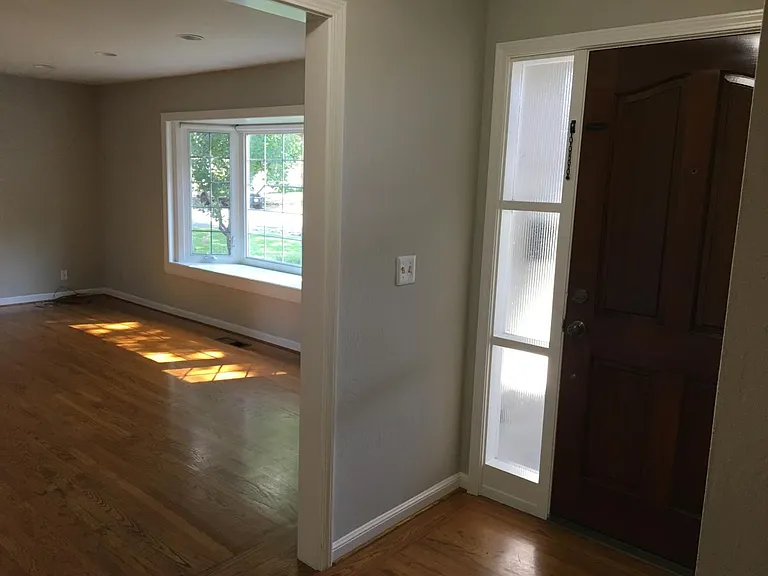 Front door, entry hall, looking into Living Room.
