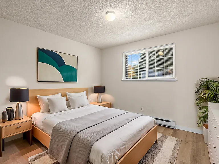 Experience tranquility in this beautifully designed bedroom featuring a plush bed and modern decor.