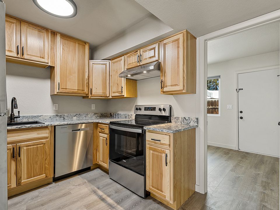 Kitchen with real wood cabinets and granite countertops finished with all stainless steel appliances.